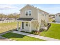 Desirable two-story home with gray siding, a charming front porch, and green space at 2039 Amelia Bay Pl, Valrico, FL 33596
