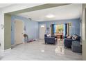 Inviting living room with blue walls, tile floors and comfortable seating area at 2174 62Nd N St, Clearwater, FL 33760
