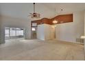 Bright living room with neutral carpet, fan, and sliding glass door leading to enclosed patio at 2527 Wrencrest Cir, Valrico, FL 33594
