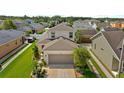 Charming two-story home boasts a well-manicured lawn and attached two-car garage in a neatly organized residential area at 32718 Harmony Oaks Dr, Wesley Chapel, FL 33545