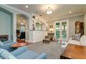 Inviting living room featuring a built-in bar, an area rug, and hardwood floors at 3714 W San Juan St, Tampa, FL 33629