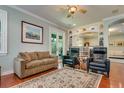 Cozy living room with hardwood floors, an area rug, built-in bookcases, and french doors at 3714 W San Juan St, Tampa, FL 33629