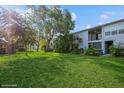 Inviting backyard with mature trees offering a serene escape and lush lawn for outdoor activities at 4325 58Th N Way # 1527, Kenneth City, FL 33709