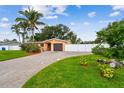 Charming single-story home with well-maintained lawn, brick driveway, and privacy fence at 4400 Helena Ne St, St Petersburg, FL 33703