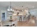 Modern kitchen featuring sleek countertops, pendant lighting, and bar stool seating at 4435 Devinshire Fields Loop, Plant City, FL 33567