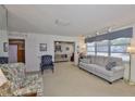 Bright living room featuring neutral carpet, comfortable seating, and an open layout to other living spaces at 513 Fairhope Dr, Apollo Beach, FL 33572