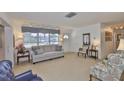 Inviting living room with neutral carpet, plenty of natural light, and comfortable seating arrangements at 513 Fairhope Dr, Apollo Beach, FL 33572