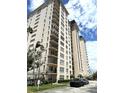 Upscale high-rise residential building featuring multiple balconies and parking area in front at 5220 Brittany S Dr # 1306, St Petersburg, FL 33715