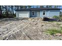 Exterior of home showcasing construction and a front yard with a driveway at 5229 Chaney Ter, Port Charlotte, FL 33981