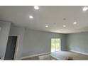 Bright living room with recessed lighting, sliding glass doors and neutral paint at 5229 Chaney Ter, Port Charlotte, FL 33981