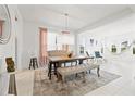 Dining room shows an open floor plan, with chandelier, bench seating arrangement, and bright decor at 5810 Fieldmoor Ct, Palmetto, FL 34221
