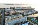 Elevated aerial view of waterfront condos overlooking a serene waterway, featuring lush landscaping and community amenities at 6020 Shore S Blvd # 1008, Gulfport, FL 33707