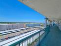 Open air balcony view overlooking meticulously lined parking, community landscaping and nearby buildings at 6020 Shore S Blvd # 1008, Gulfport, FL 33707