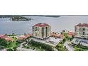 Exterior of the condo complex with parking, community pool and bay views at 6322 Palma Del Mar S Blvd # 1107, St Petersburg, FL 33715