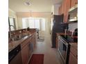 Bright kitchen with granite countertops, stainless steel appliances, and tile flooring at 6715 Grand Estuary Trl # 203, Bradenton, FL 34212