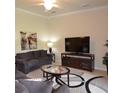 Cozy living room with comfortable seating, a ceiling fan, and a modern entertainment center at 6715 Grand Estuary Trl # 203, Bradenton, FL 34212
