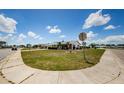 Street view showcasing a well-maintained lawn and mature landscaping on a corner lot at 801 Oakmont Ave, Sun City Center, FL 33573