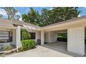 Charming home exterior featuring a covered carport and well-maintained landscaping at 9307 Golf View Dr, New Port Richey, FL 34655