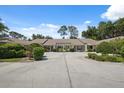 Property featuring large driveway with well maintained lawn and shrubbery at 9307 Golf View Dr, New Port Richey, FL 34655