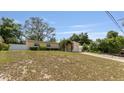A spacious home featuring a large front yard and a well-maintained exterior with plenty of natural light at 10912 N 61St St, Temple Terrace, FL 33617