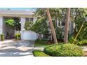 The front elevation of the home is enhanced by tropical landscaping, an attached garage, and a driveway at 1211 W Horatio St # A, Tampa, FL 33606