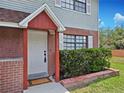 Close up of front door with brick accent and house number at 12701 N 57Th St, Tampa, FL 33617