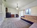 Spacious living room with carpet floors, an overhead light fixture, and plenty of natural light at 12701 N 57Th St, Tampa, FL 33617