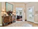 Beautiful foyer with tile flooring, wooden console table, and decorative glass door leading to home office at 15135 Azra Dr, Odessa, FL 33556