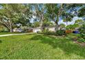 Lovely single-story home with mature trees and a green lawn in a peaceful neighborhood setting at 1524 Essex N Dr, St Petersburg, FL 33710