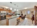Open-concept kitchen featuring an island with bar seating and views into the living area at 1524 Essex N Dr, St Petersburg, FL 33710