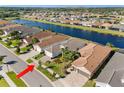 Aerial view of the home in a lakeside community with lush landscaping and well-maintained streets at 15528 Corona Del Mar Dr, Wimauma, FL 33598