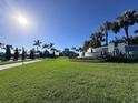 The Valencia community entrance is beautifully landscaped with lush green lawns and vibrant palm trees at 15528 Corona Del Mar Dr, Wimauma, FL 33598