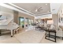 Elegant living room boasts high ceilings, neutral decor, and seamless indoor-outdoor flow at 15528 Corona Del Mar Dr, Wimauma, FL 33598