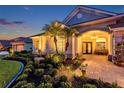 Elegant front entrance with stone accents, a double-door entry, and beautifully landscaped garden at 1617 El Pardo Dr, Trinity, FL 34655