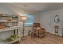 Comfortable living area with wood-look floors, plenty of natural light, and a cozy seating area at 1710 Belleair Forest Dr # A, Belleair, FL 33756