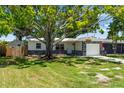 Charming single-story home featuring beautiful rock accents and a well-manicured lawn at 1851 Oklahoma Ne Ave, St Petersburg, FL 33703
