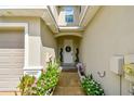 Charming front entryway featuring decorative plants and a welcoming front door at 1962 Marlington Way, Clearwater, FL 33763