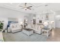Bright living room with cozy furniture, tray ceiling, and an open kitchen layout at 19652 Ship Wheel Way, Land O Lakes, FL 34638