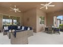 Relaxing outdoor patio with comfortable wicker furniture, ceiling fans, and string lights at 19652 Ship Wheel Way, Land O Lakes, FL 34638