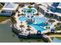 Aerial view of a luxurious resort-style pool with multiple pools, lounge areas, and lush landscaping at 19652 Ship Wheel Way, Land O Lakes, FL 34638