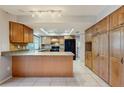 Spacious kitchen featuring wood cabinetry, granite countertops, tile floors and modern appliances at 2138 Viola Dr, Clearwater, FL 33764