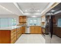 Bright kitchen with granite countertops, tile flooring, and stainless steel appliances at 2138 Viola Dr, Clearwater, FL 33764