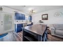 Open kitchen with an island, stainless steel appliances, white countertops, and sleek, modern lighting at 2426 17Th N Ave, St Petersburg, FL 33713