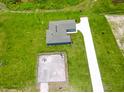 Aerial view of home featuring an extended driveway, large yard, and fenced-in area for outdoor activities at 2426 Hiers Rd, Dover, FL 33527