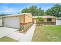 Charming single-story home featuring a well-maintained lawn and a two-car garage at 3072 Sugar Bear Trl, Palm Harbor, FL 34684