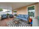 Inviting screened-in patio with comfortable seating, perfect for relaxation and outdoor enjoyment at 3230 Bellericay Ln, Land O Lakes, FL 34638