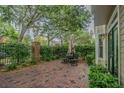 Private brick patio area with seating, mature trees, and lush landscaping at 350 2Nd N St # 1, St Petersburg, FL 33701