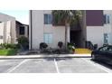 Close up of the condos showing yellow stairs leading up to the front door with nearby landscaping at 3814 N Lake Dr # 65, Tampa, FL 33614