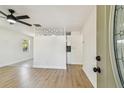 Bright living room with new light wood flooring, a stylish divider wall, and view to the eat-in kitchen at 3818 Grove S St, St Petersburg, FL 33705