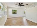 Open-concept living area with light wood flooring, plenty of natural light, and modern ceiling fan at 3818 Grove S St, St Petersburg, FL 33705